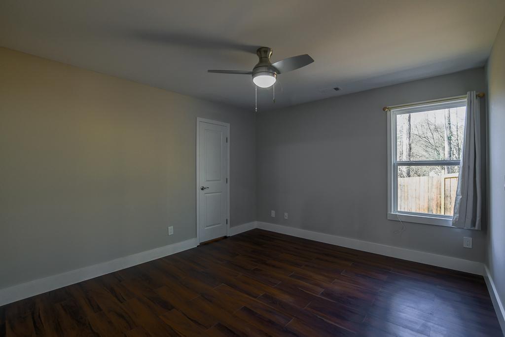1020 Riverbend Road Commerce, GA 30530 - Photo 16 of 38 an empty room with wooden floor and windows