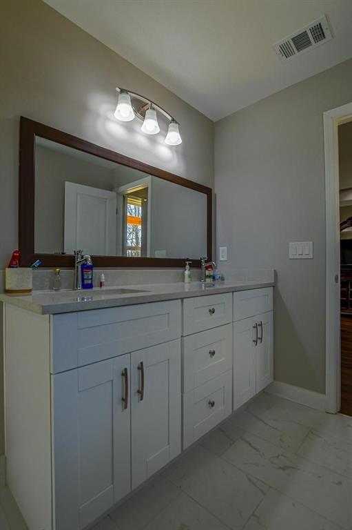 1020 Riverbend Road Commerce, GA 30530 - Photo 17 of 38 a bathroom with double sink and a mirror