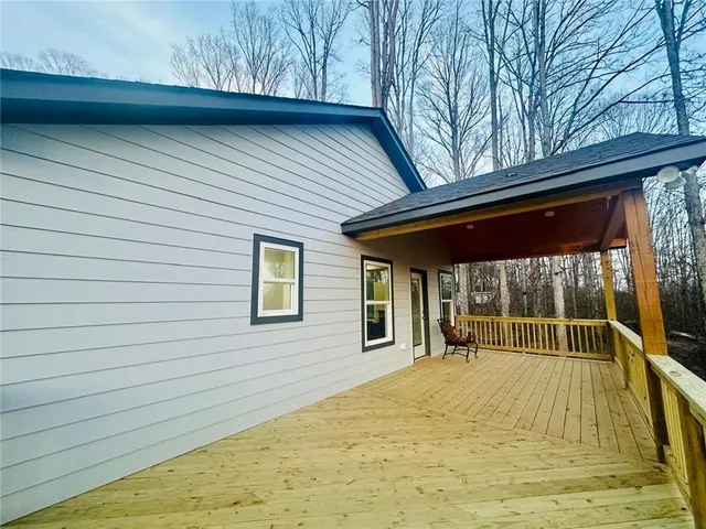 a view of swimming pool with large trees and plants