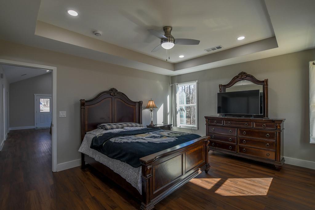 1020 Riverbend Road Commerce, GA 30530 - Photo 24 of 38 a bedroom with a bed and a flat screen tv