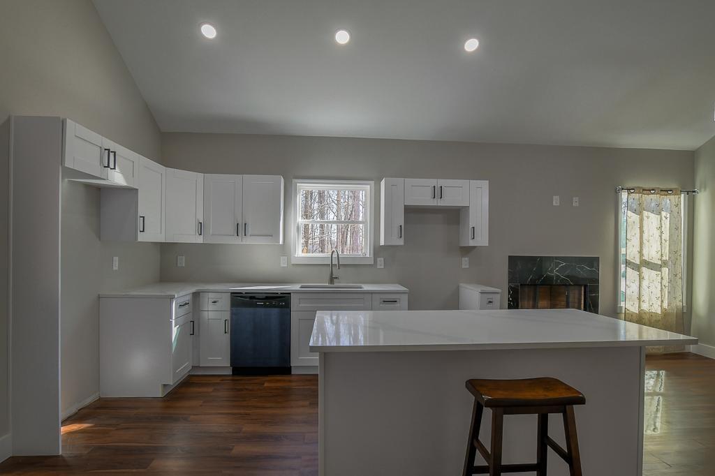 1020 Riverbend Road Commerce, GA 30530 - Photo 6 of 38 a kitchen with stainless steel appliances a sink a stove a refrigerator white cabinets and wooden floor
