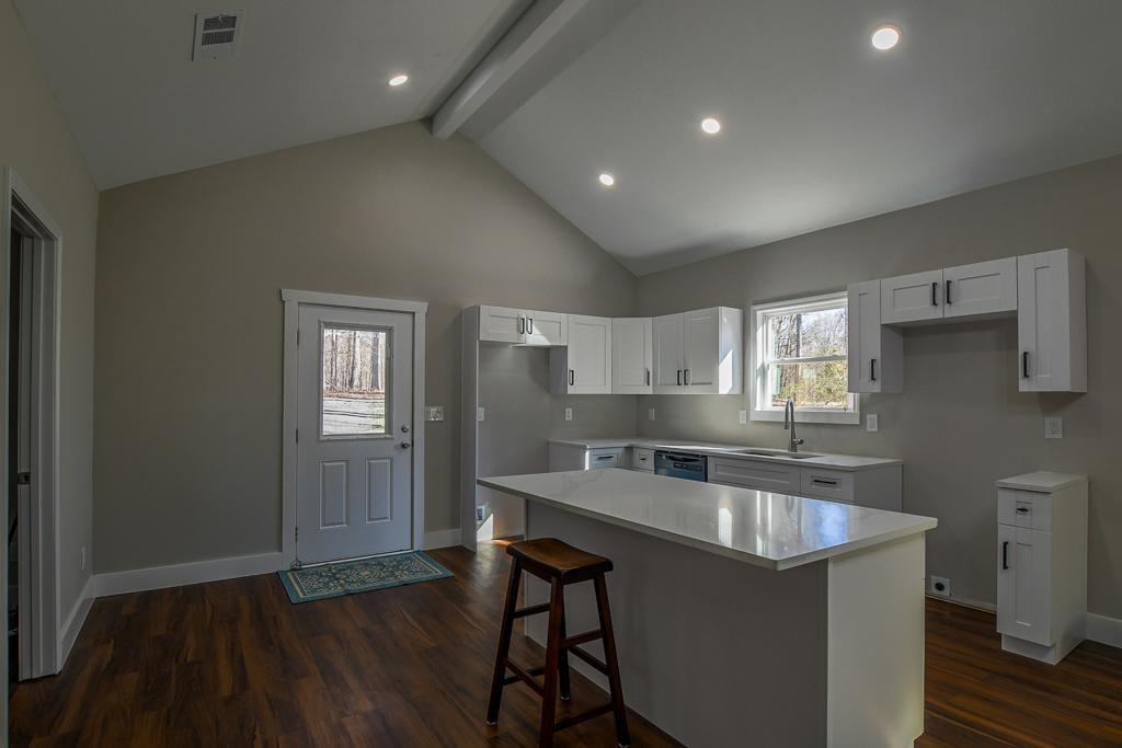 1020 Riverbend Road Commerce, GA 30530 - Photo 7 of 38 a kitchen with sink cabinets and wooden floor