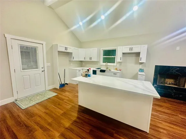 a kitchen with a sink a stove and cabinets