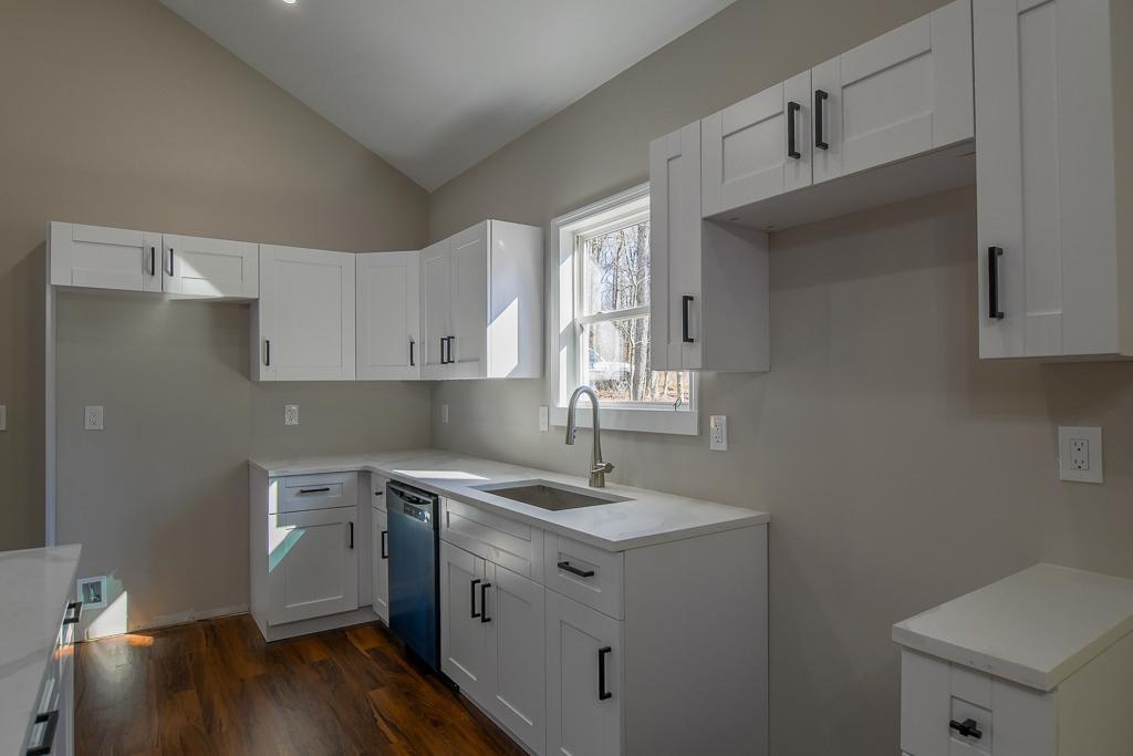 1020 Riverbend Road Commerce, GA 30530 - Photo 10 of 38 a kitchen with a sink cabinets and wooden floor