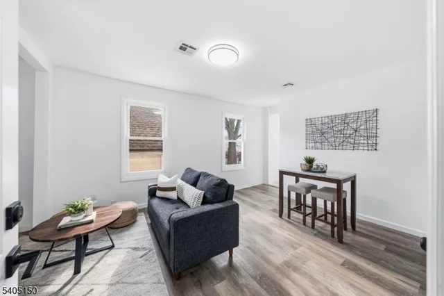 a living room with furniture rug and window