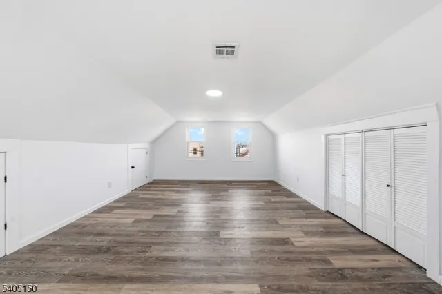 a view of an empty room and wooden floor