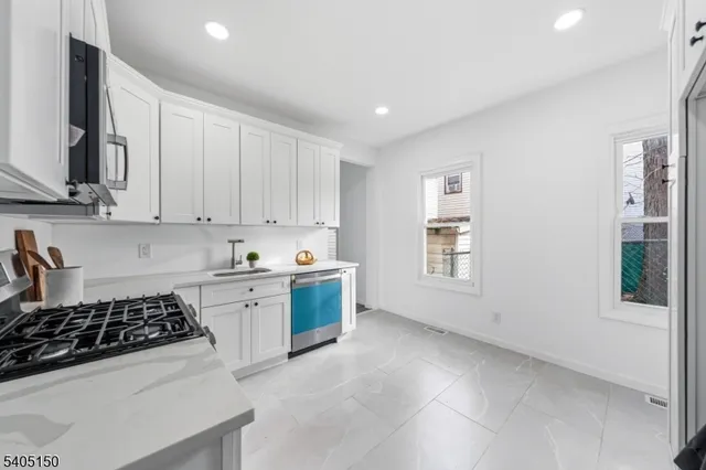 a kitchen with a stove a sink and a microwave