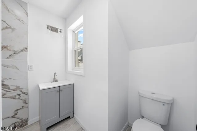 a bathroom with a sink mirror and toilet