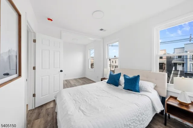 a bedroom with bed and window