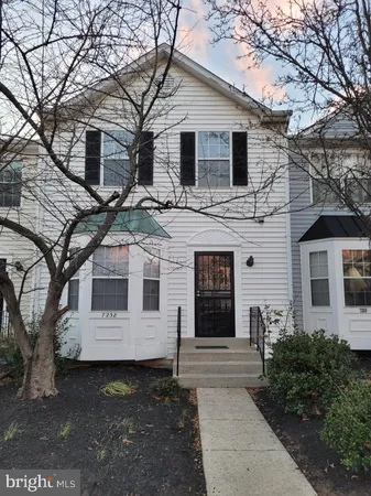 a front view of a house with yard
