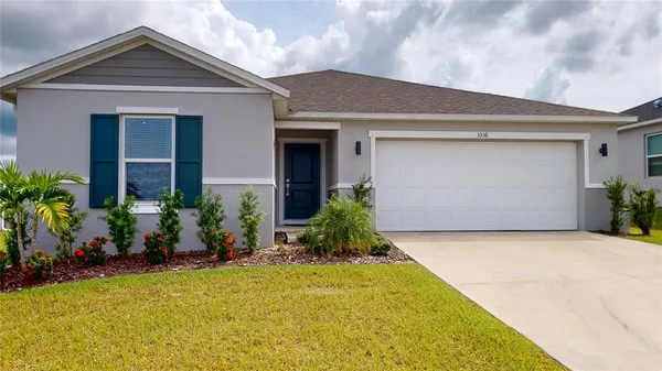 a front view of house with green space