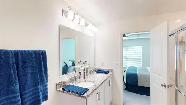 a bathroom with a sink vanity granite and a mirror