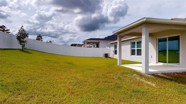 a view of an house with swimming pool and porch