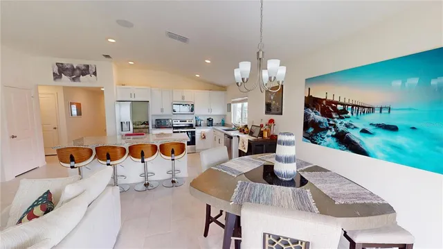 a living room with dining room and kitchen view