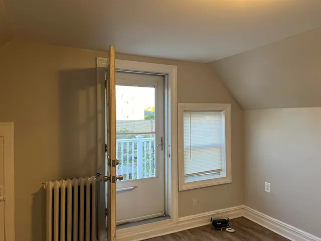 a white toilet sitting next to a window