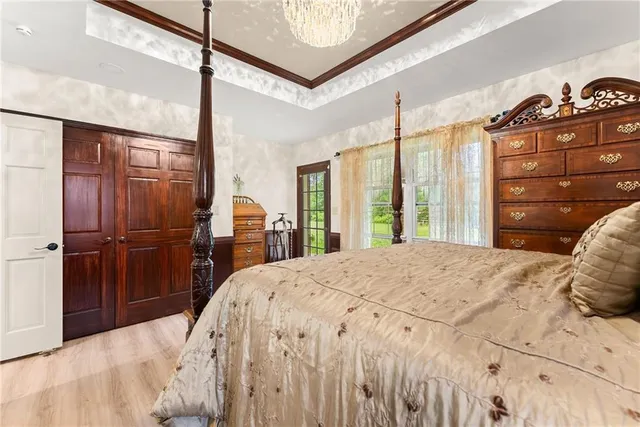 a bed sitting in a bedroom next to a window