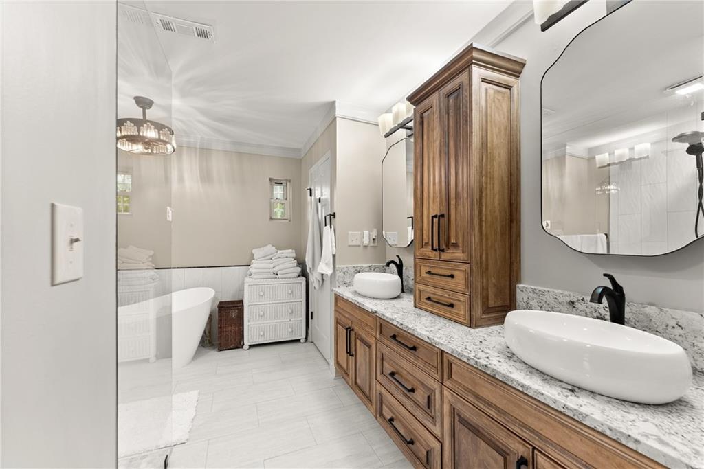 7215 Kelly Bridge Road Dawsonville, GA 30534 - Photo 15 of 87 a en suite bathroom with a double vanity sink a mirror and a shower