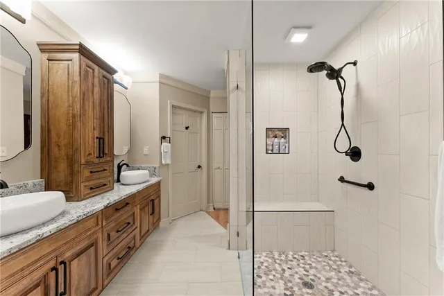 a bedroom with a bed and a dresser with mirror