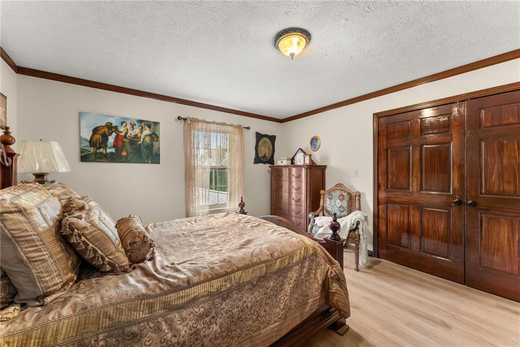 7215 Kelly Bridge Road Dawsonville, GA 30534 - Photo 21 of 87 a bed sitting in a bedroom next to a window