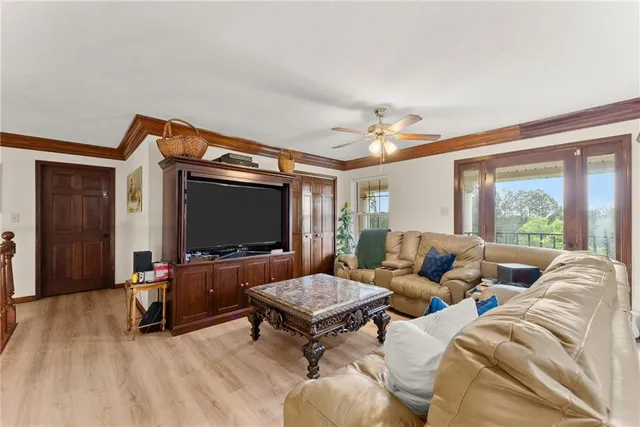 a kitchen with stainless steel appliances granite countertop a stove a refrigerator a sink a dining table and chairs with wooden floor