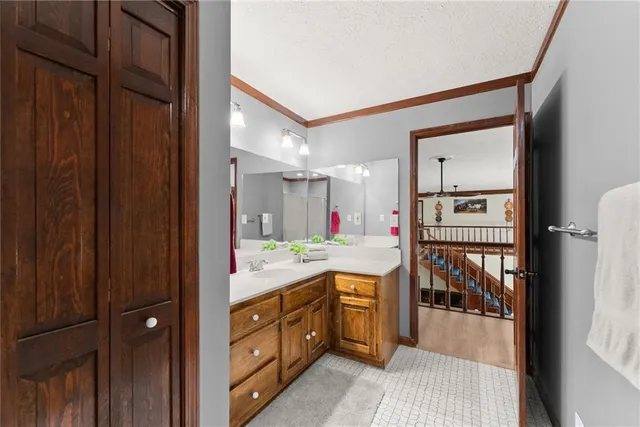 a kitchen with granite countertop a stove a sink dishwasher and a refrigerator with wooden cabinets