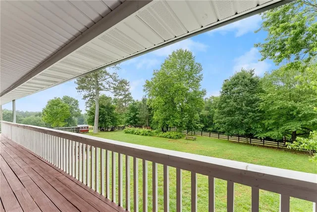 a view of a lake with table and chairs under an umbrella