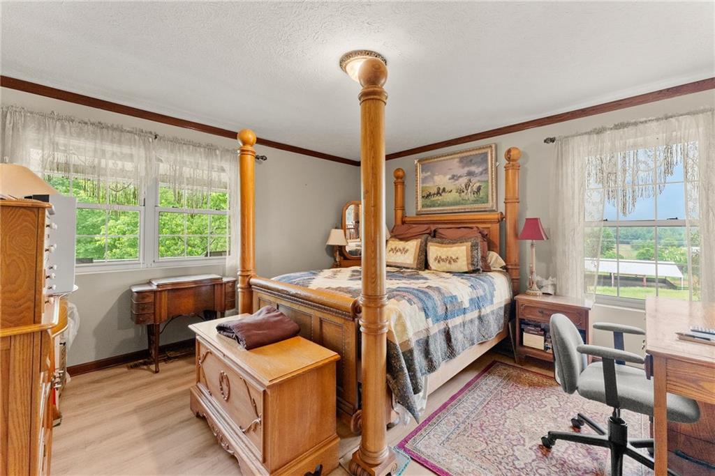 7215 Kelly Bridge Road Dawsonville, GA 30534 - Photo 35 of 87 a bedroom with a bed and wooden floor