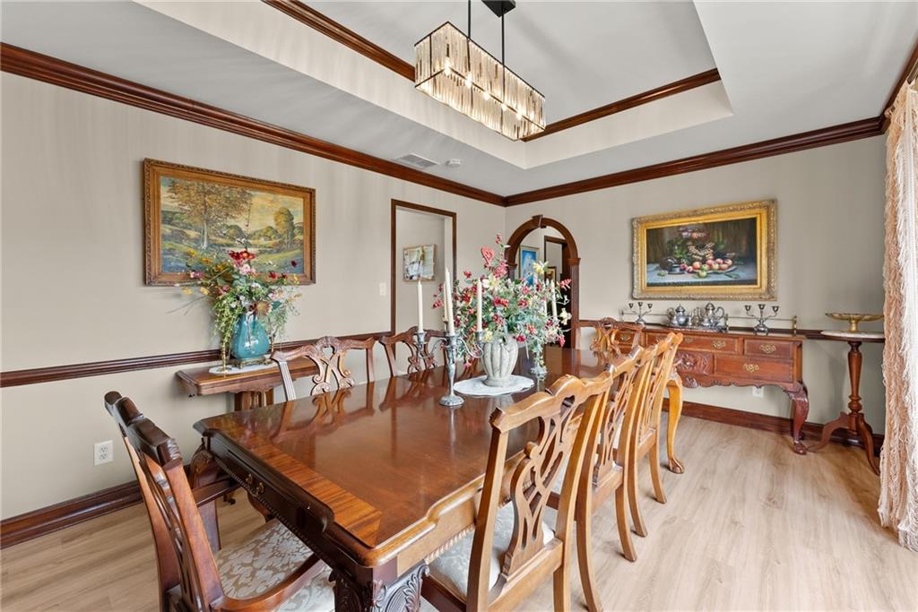 7215 Kelly Bridge Road Dawsonville, GA 30534 - Photo 44 of 87 a view of a dining room with furniture wooden floor and a chandelier