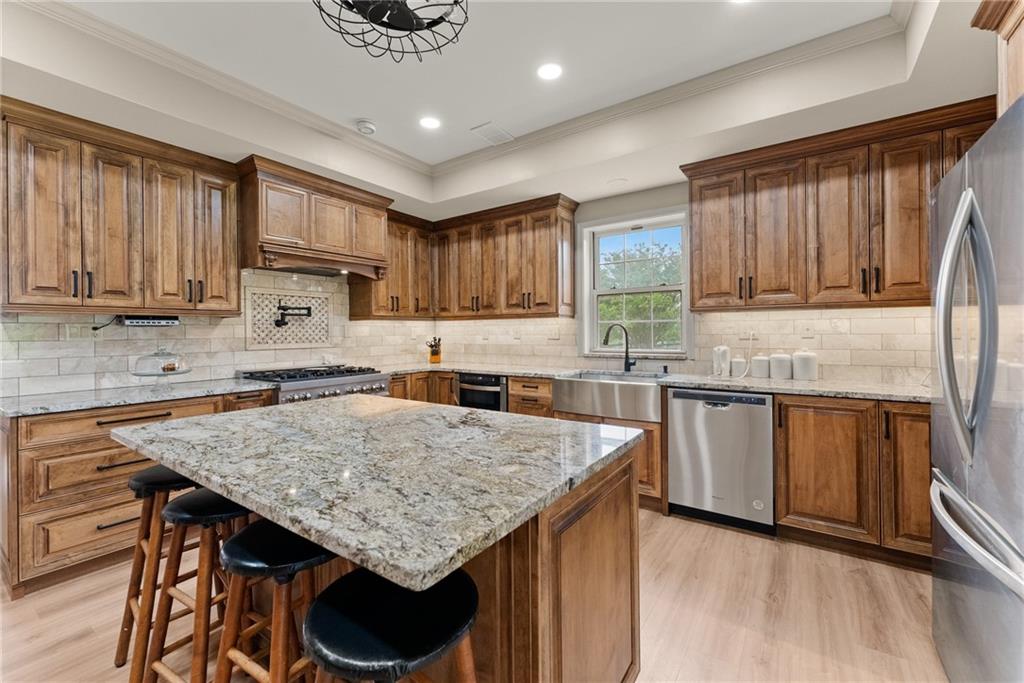 7215 Kelly Bridge Road Dawsonville, GA 30534 - Photo 46 of 87 a kitchen with granite countertop a stove a sink dishwasher and a refrigerator with wooden cabinets