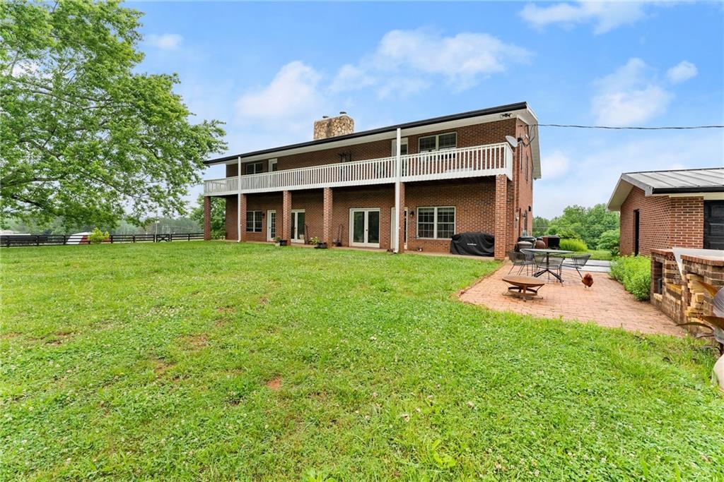7215 Kelly Bridge Road Dawsonville, GA 30534 - Photo 50 of 87 a view of a house with backyard porch and sitting area