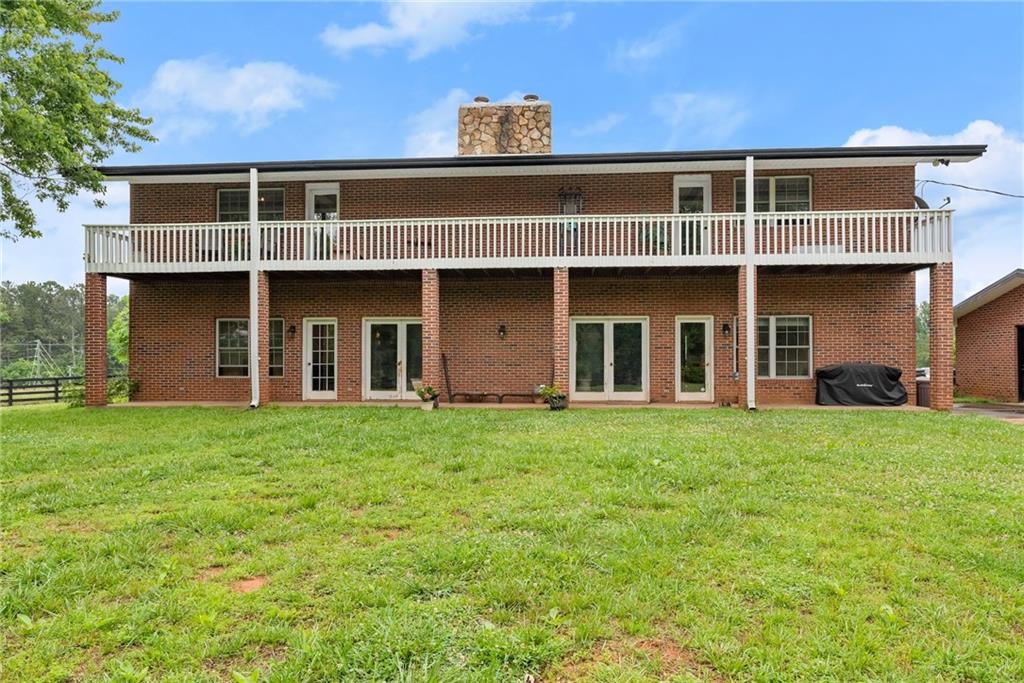 7215 Kelly Bridge Road Dawsonville, GA 30534 - Photo 52 of 87 a front view of a house with a garden