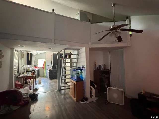 a view of a room with wooden floor and furniture