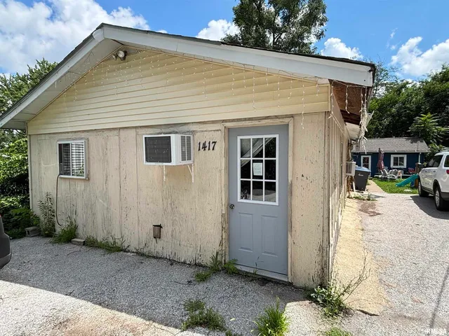 a living room with furniture and a gym equipment