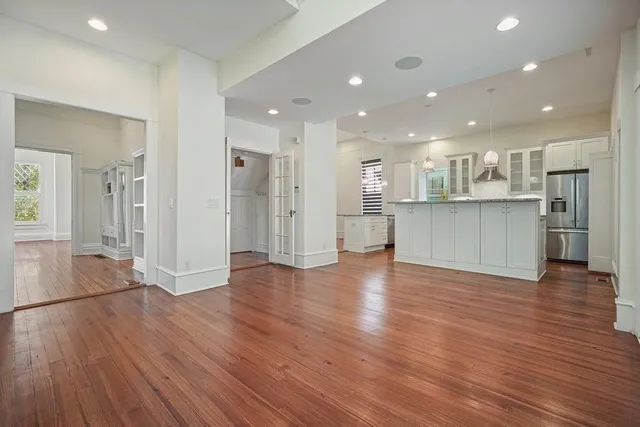 a view of a kitchen with a wooden floor and a large window