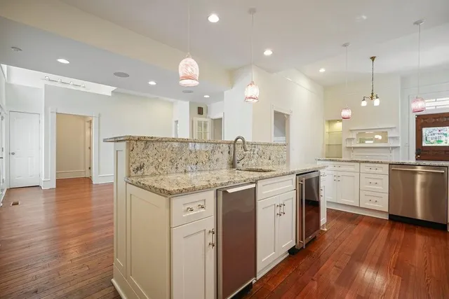 a kitchen with a sink window and stainless steel appliances