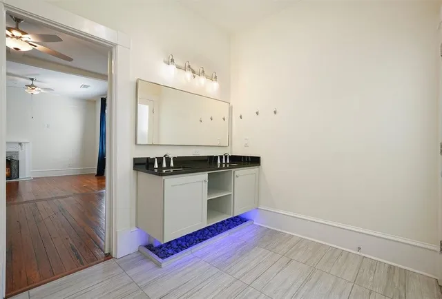 a kitchen with granite countertop white cabinets and white appliances