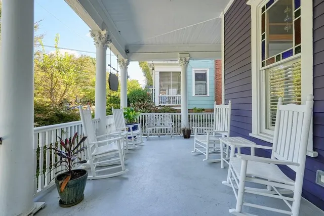 a balcony view with couple of chairs and a stove