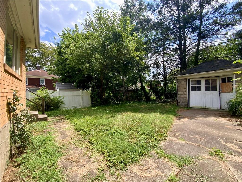 1109 Progress Street McKees Rocks, PA 15136 - Photo 27 of 30 a backyard of a house with plants and large tree