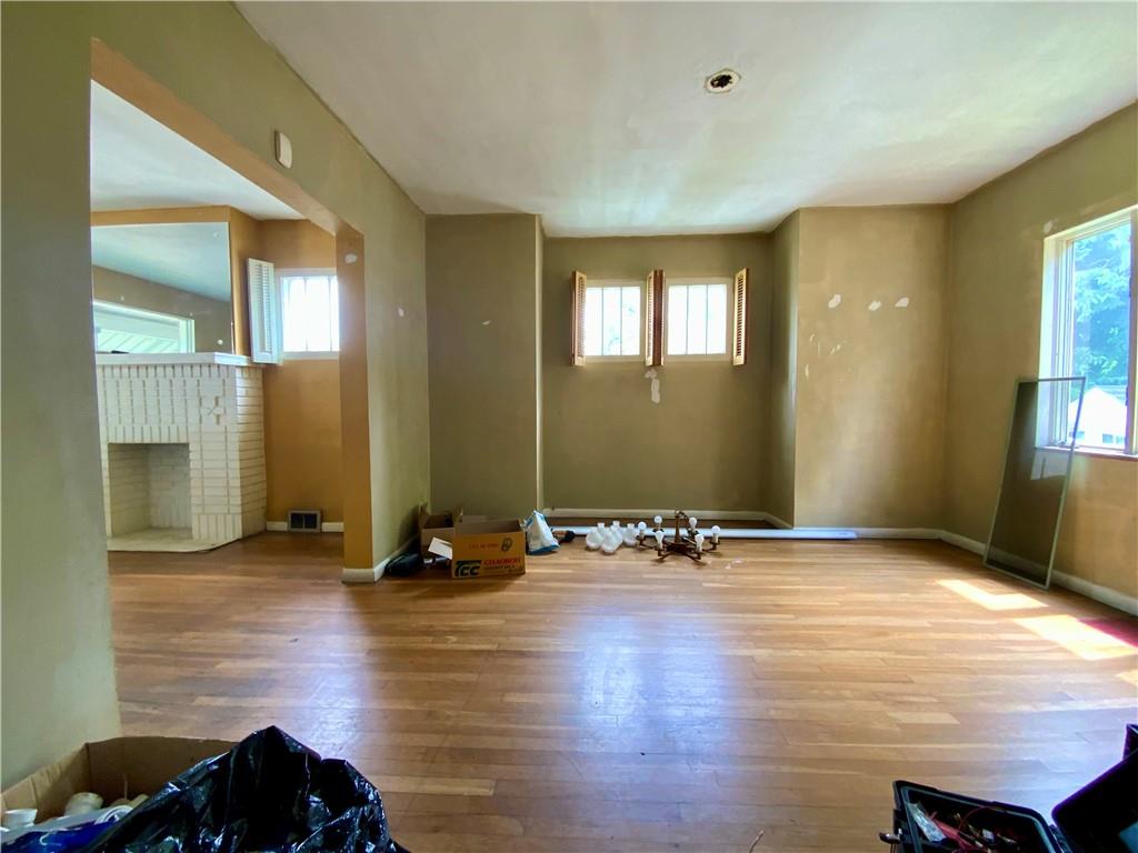 1109 Progress Street McKees Rocks, PA 15136 - Photo 9 of 30 a view of room with a ceiling fan wooden floor and windows