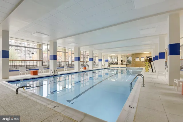a view of a room with gym equipment and floor to ceiling window