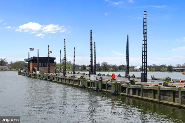 a view of a lake with boats next to a bridge