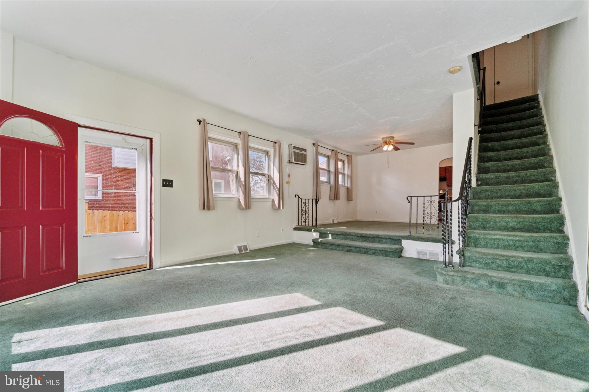 732 East 25th Street Chester, PA 19013 - Photo 4 of 25 a view of a livingroom with stairs and a fireplace