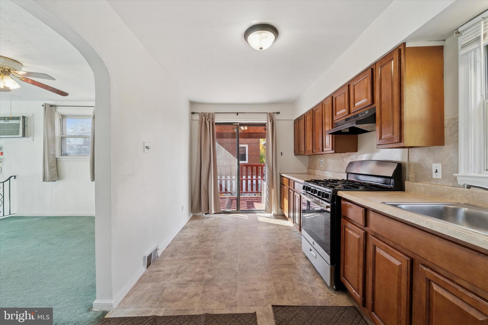 732 East 25th Street Chester, PA 19013 - Photo 9 of 25 a kitchen with stainless steel appliances granite countertop a refrigerator a sink dishwasher a stove with wooden cabinets and floor