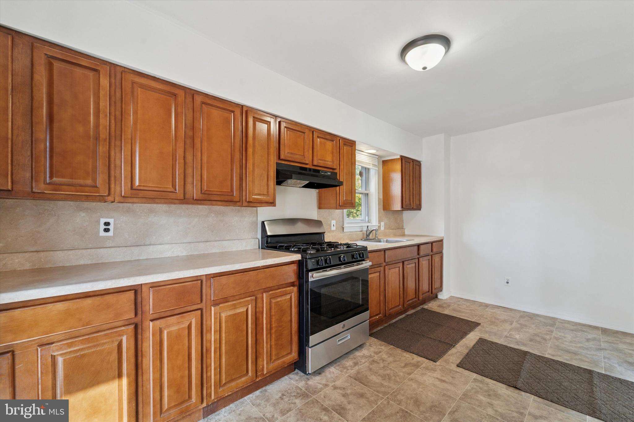 732 East 25th Street Chester, PA 19013 - Photo 10 of 25 a kitchen with stainless steel appliances granite countertop a stove a sink dishwasher and a refrigerator