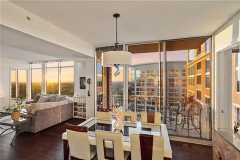 a living room with furniture a chandelier and a flat screen tv