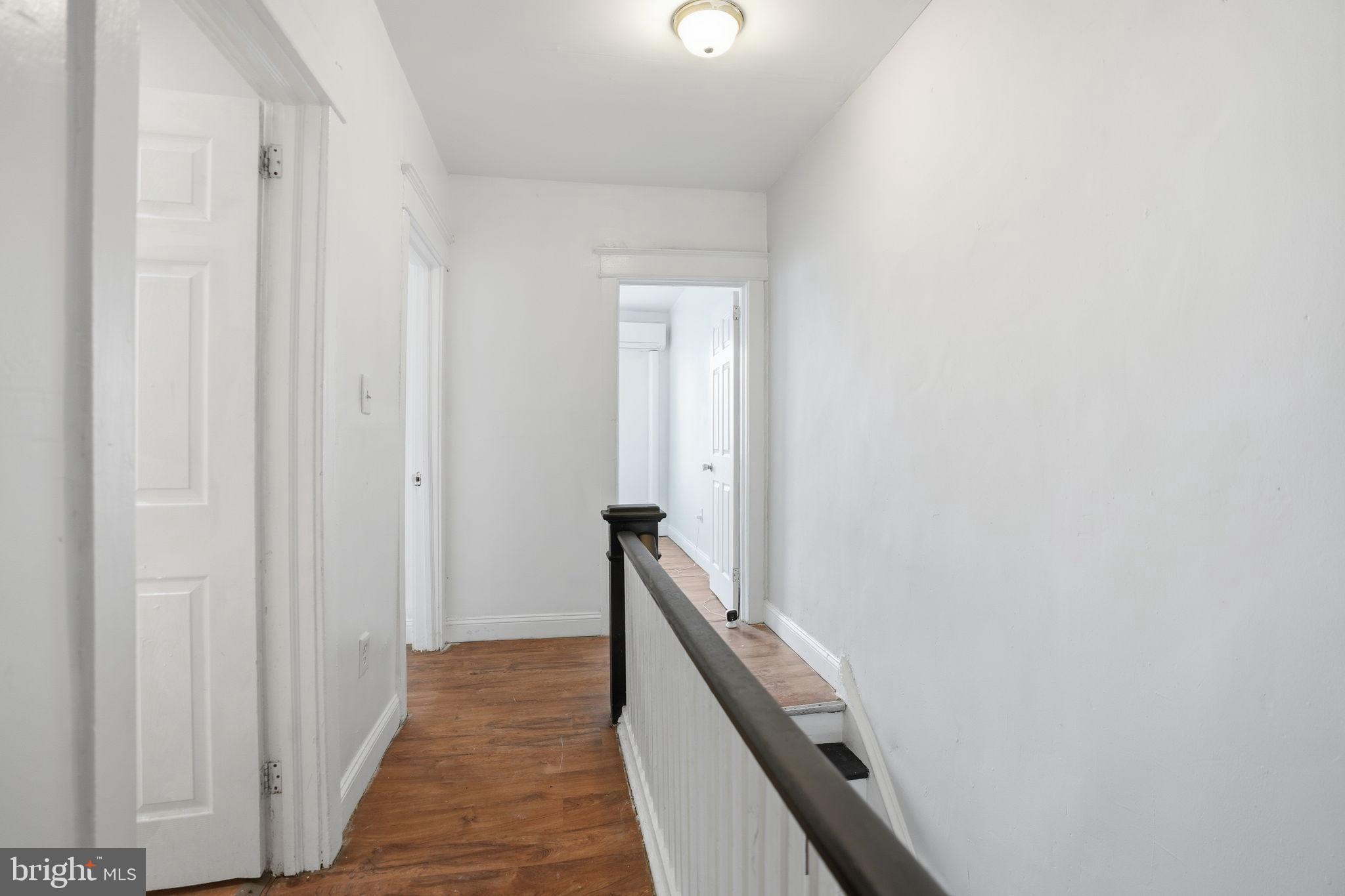 5563 Blakemore Street Philadelphia, PA 19138 - Photo 11 of 22 a view of a hallway with wooden floor and staircase