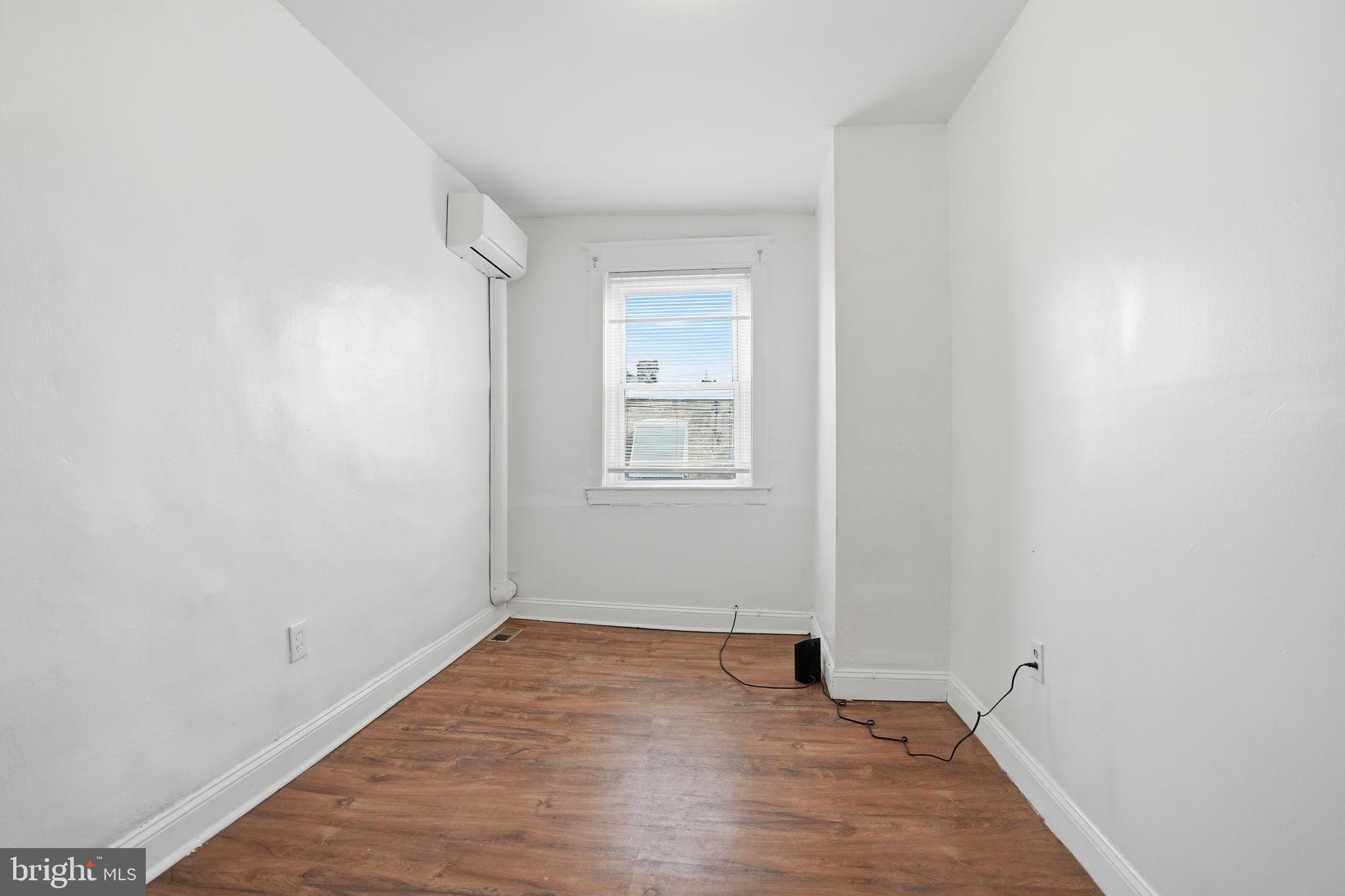 5563 Blakemore Street Philadelphia, PA 19138 - Photo 13 of 22 an empty room with wooden floor and windows