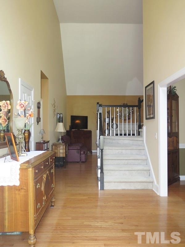 7801 Housewren Place Raleigh, NC 27613 - Photo 3 of 23 a living room with furniture and a wooden floor