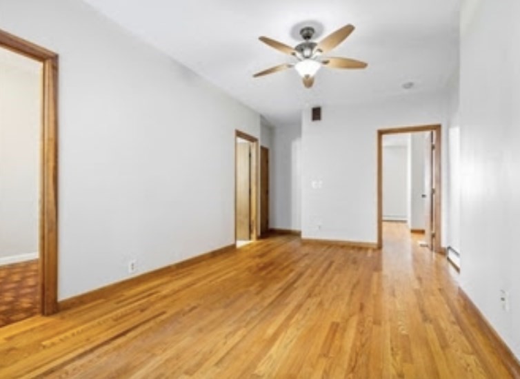 156 Lexington Street, Unit 1 Boston, MA 02128 - Photo 5 of 12 a view of an empty room with wooden floor
