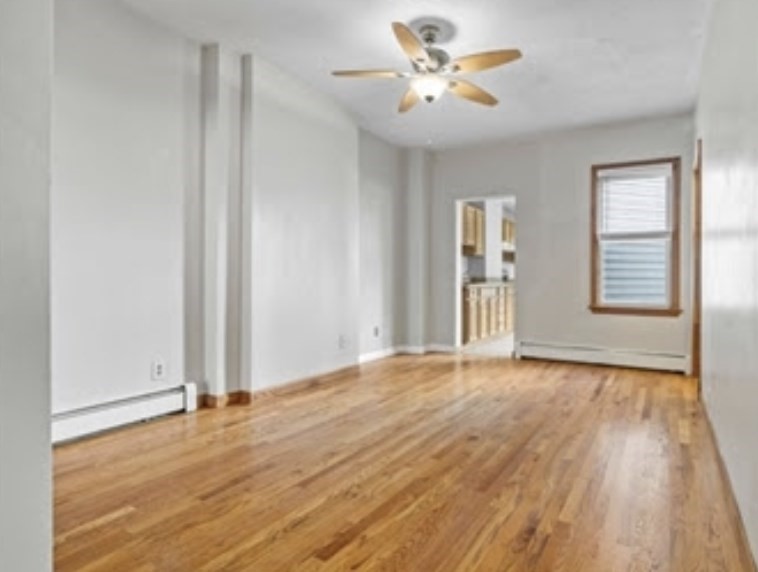 156 Lexington Street, Unit 1 Boston, MA 02128 - Photo 6 of 12 a view of an empty room with window and wooden floor
